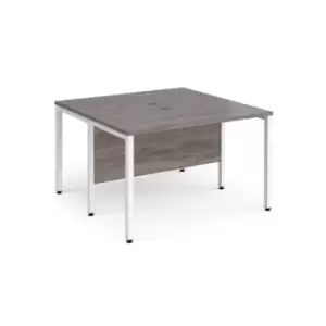 Image of Maestro 25 back to back straight desks 1200mm x 1200mm - white bench leg frame and grey oak top