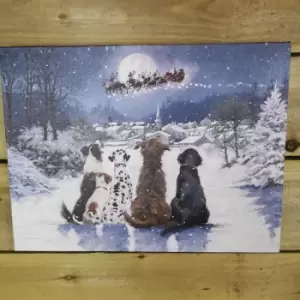Image of Battery Operated Fibre Optic 40x30cm Christmas Dogs Watching Santa Fly Over Village Canvas