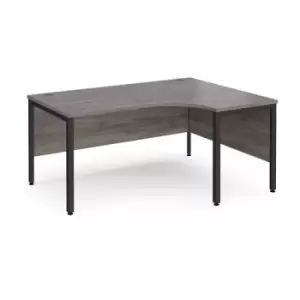 Image of Maestro 25 right hand ergonomic desk 1600mm wide - Black bench leg frame and grey oak top