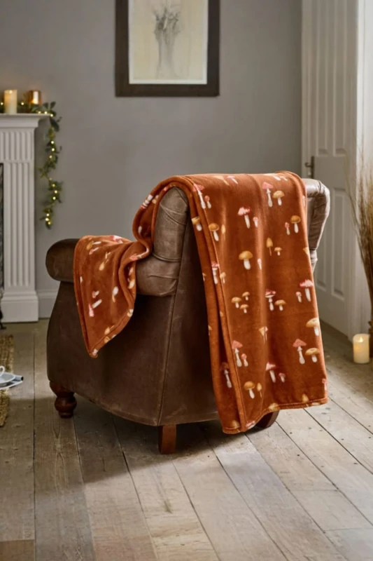 Image of Deyongs Deyongs Toadstool Scatter Throw Rust - Mushroom Print Autumn Fleece Blanket 140x180cm in Terracotta Size: 140cm x 180cm Terracotta 140cm x 1