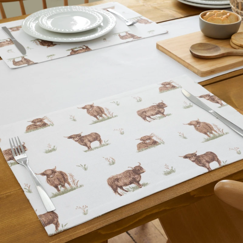 Image of Catherine Lansfield Catherine Lansfield 'Angus Highland Cow' Cotton Dining Placemat 4 Pack in Natural Natural One Size Unisex 5057681188294