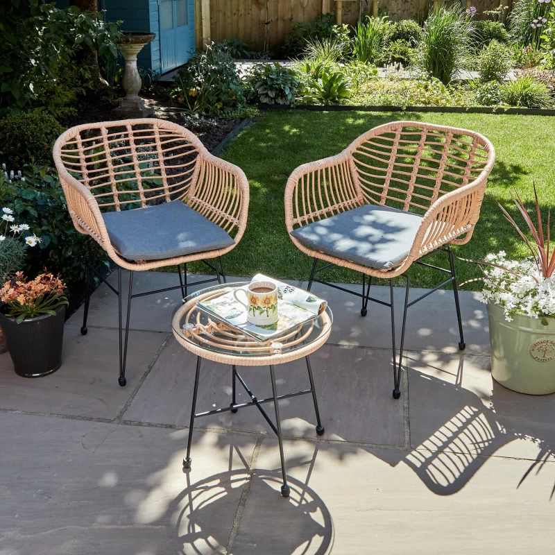 Image of Home Source Flora Outdoor Table And Chair Set Natural Wicker Frame Black Steel Legs Glass Tabletop