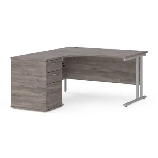 Image of Maestro 25 left hand ergonomic desk 1400mm with silver cantilever frame and desk high pedestal - grey oak