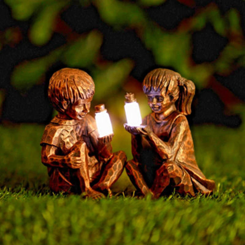 Image of Solar Powered Boy And Girl With Fireflies Statue Resin Home Garden Ornament