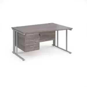Image of Maestro 25 right hand wave desk 1400mm wide with 3 drawer pedestal - silver cable managed leg frame and grey oak top