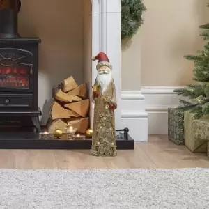 Image of The Winter Workshop - Santa the 53cm Indoor Fire Place Father Christmas with Red Hat Holding LED Gold Tree Decoration Resin Figure