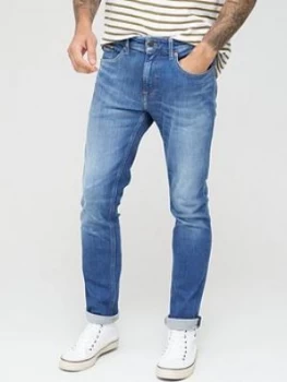 Image of Tommy Jeans Austin Slim Tapered Jeans - Mick Mid Blue