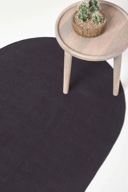 Image of Homescapes Black Handmade Woven Braided Oval Rug, 110 X 170 Cm