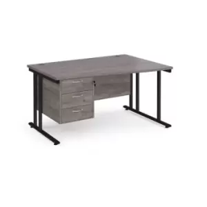 Image of Maestro 25 right hand wave desk 1400mm wide with 3 drawer pedestal - Black cantilever leg frame and grey oak top