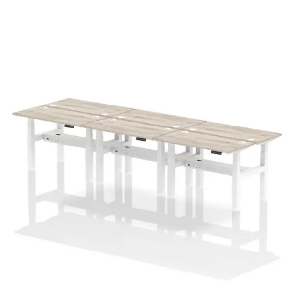 Image of Air Air Back-to-Back 1200 x 600mm Height Adjustable 6 Person Bench Desk Grey Oak Top with Cable Ports White Frame HASCP6P12600GRYW