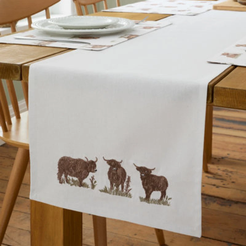 Image of Catherine Lansfield Catherine Lansfield 'Angus Highland Cow' Cotton 33x220cm Dining Table Runner in Natural Natural One Size Unisex 5057681188324