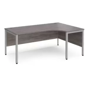 Image of Maestro 25 right hand ergonomic desk 1800mm wide - silver bench leg frame and grey oak top