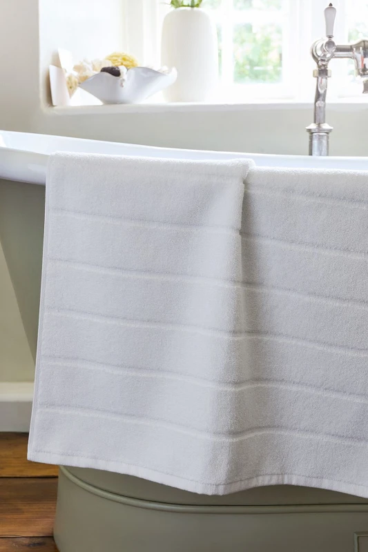 Image of Christy CHRISTY 'Signum' Heavyweight 100% Combed Cotton Bath Mat in White White One Size Unisex 5057241204686