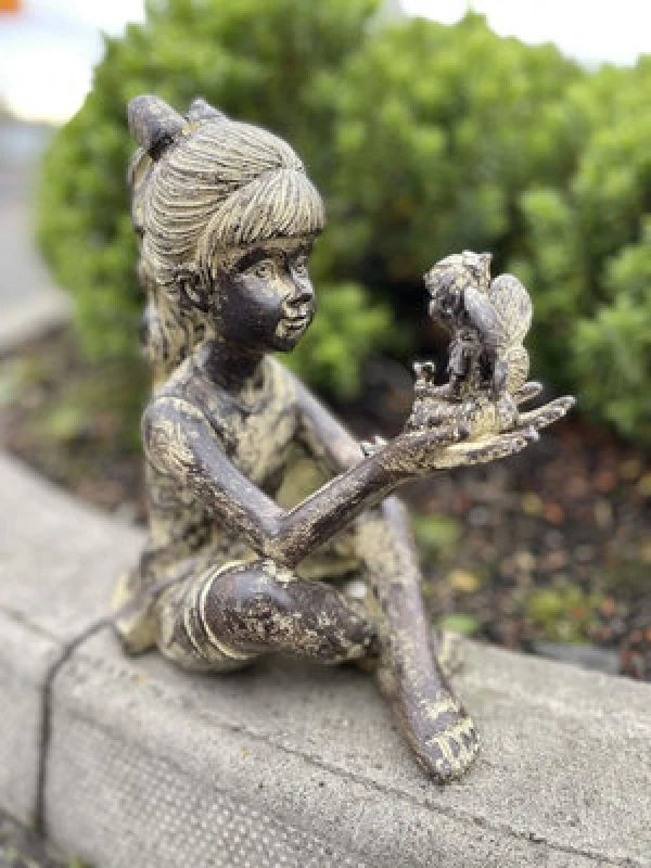 Image of Sitting Girl With Fairy Garden Ornament