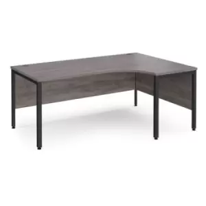 Image of Maestro 25 right hand ergonomic desk 1800mm wide - Black bench leg frame and grey oak top