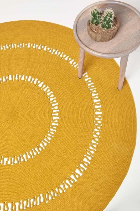 Image of Homescapes Crochet Braided Round Rug in Mustard Size: 120cm diameter Mustard Unisex 120cm diameter
