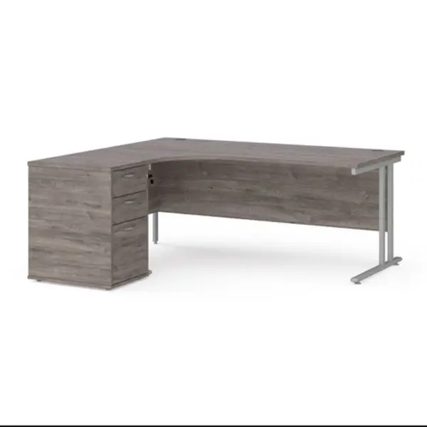 Image of Maestro 25 left hand ergonomic desk 1800mm with silver cantilever frame and desk high pedestal - grey oak