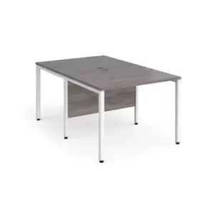 Image of Maestro 25 back to back straight desks 1000mm x 1600mm - white bench leg frame and grey oak top