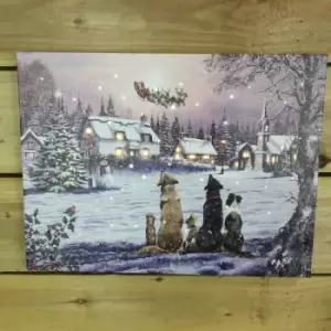 Image of Battery Operated Christmas 40x30cm Dogs Watching Santa Sleigh Over Village Canvas